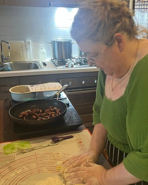 Krissy kneading fresh pasta dough in her kitchen